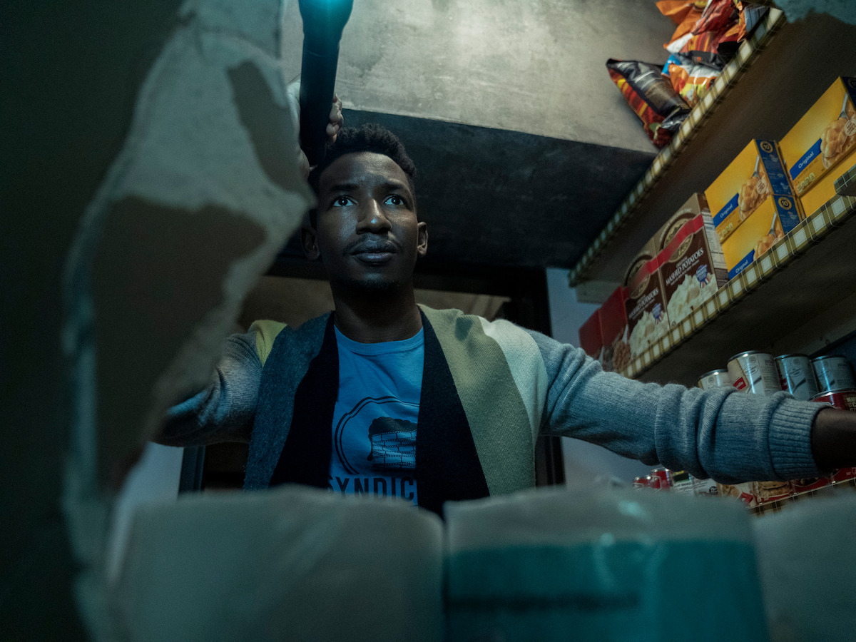 Dan Turner looks in the pantry while investigating the house in 'Archive 81'