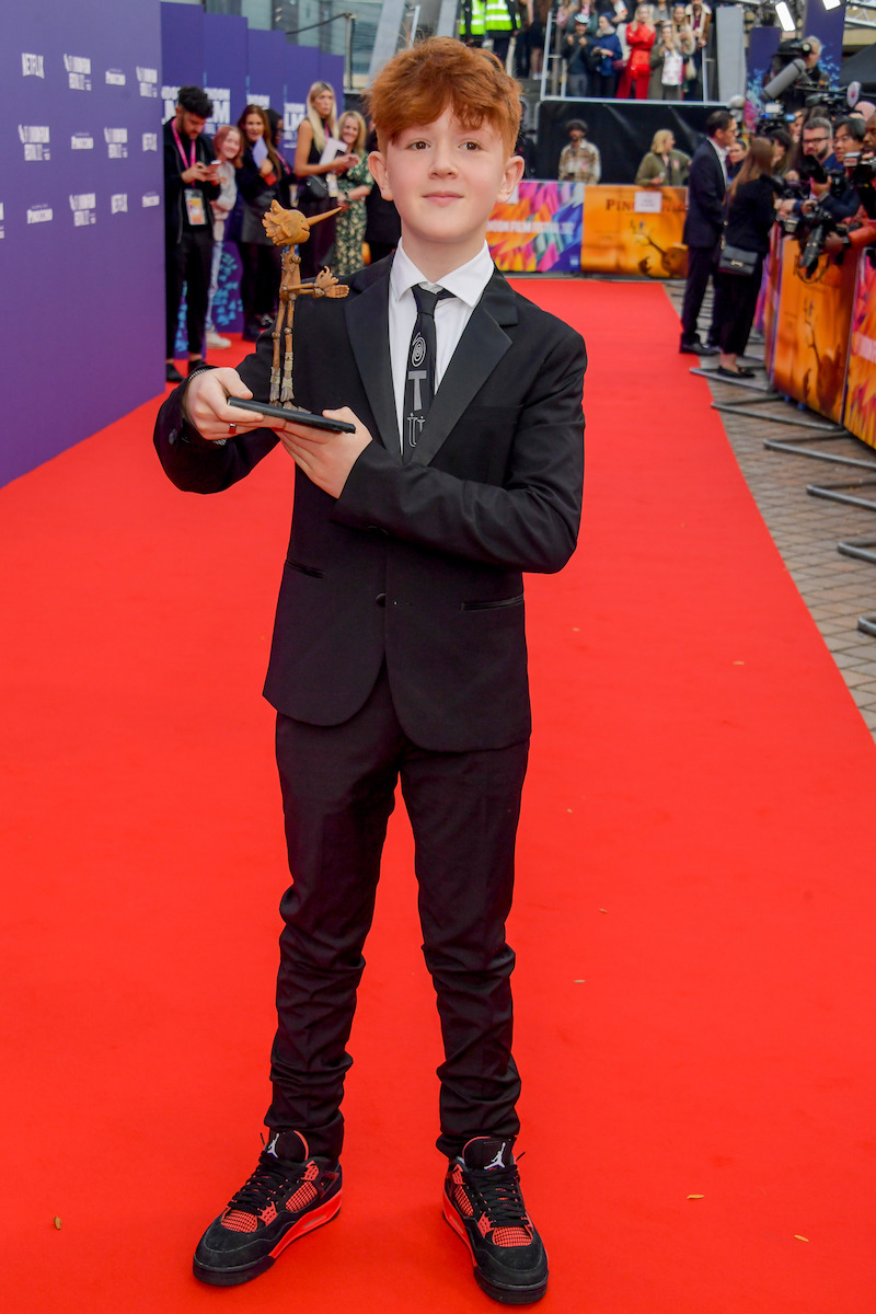 Gregory Mann poses with a mini Pinocchio. -  ‘Guillermo del Toro’s Pinocchio’ Cast at the London Film Festival