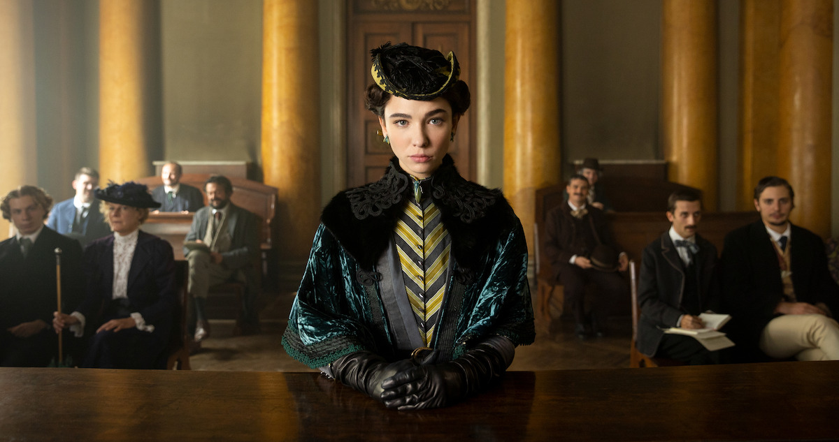 A woman stands in front of a court room