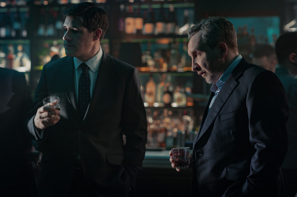 Rich Sommer as Paul and Eddie Marsan as Campbell hold drinks while standing at a bar.