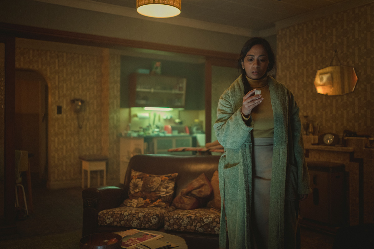 Anjana Vasan as Nida in Black Mirror Season 6 standing in a robe.