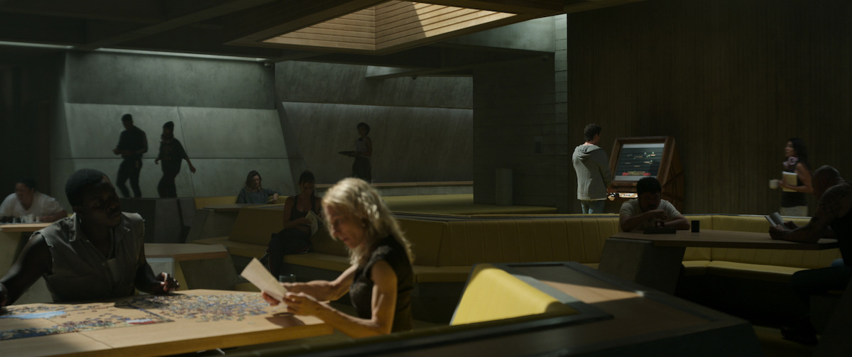 Light and shadows cut across the unsettling walls of the structure’s asymmetrical interior - The Beauty of Brutalism: the Design References in ‘Spiderhead’ Revealed