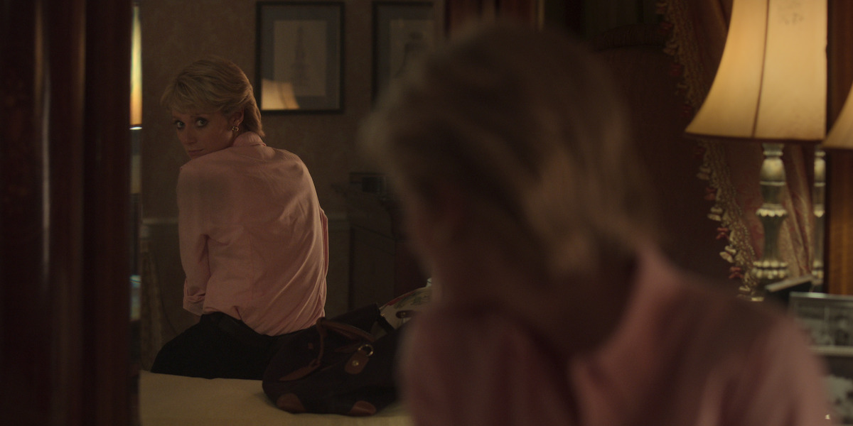 Debicki as Princess Diana looks over her shoulder to see her reflection in a mirror.