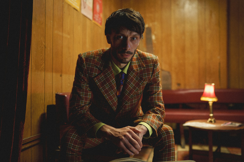 Richard Gadd as Donny Dunn wears a brown suit in 'Baby Reindeer'