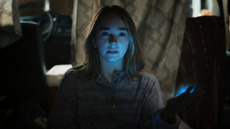 woman with her face illuminated by a screen