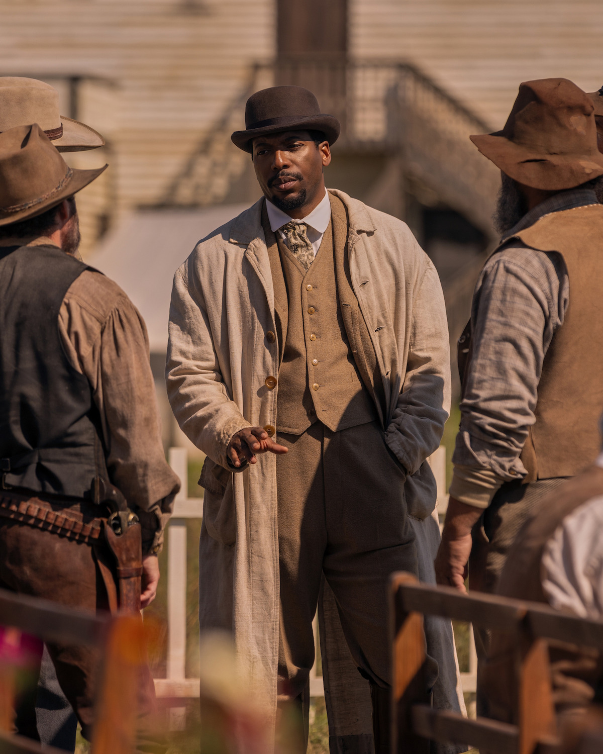A man speaks to another group of men.
