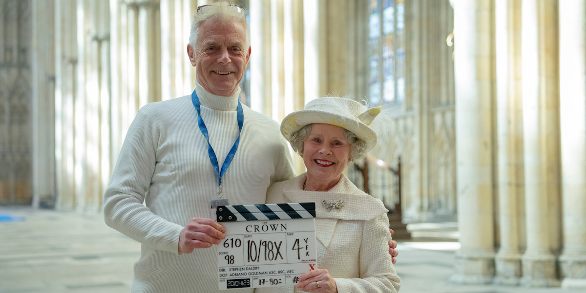 Director Stephen Daldry and Imelda Staunton stand together holding a clapboard on the final day on set of Season 6 Part 2 of ‘The Crown’