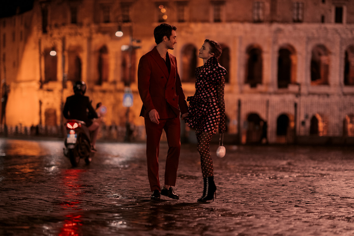 Eugenio Franceschini as Marcello and Lily Collins as Emily walk the streets of Rome in Season 4 of ‘Emily in Paris’