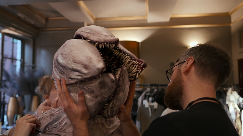A man holds a demogorgon prop in 'Behind the Curtain: Stranger Things: The First Shadow' 
