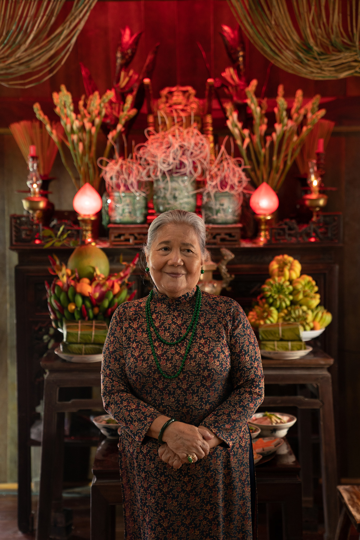 A woman stands in front of an altar in a still from ‘A Tourist’s Guide to Love.'