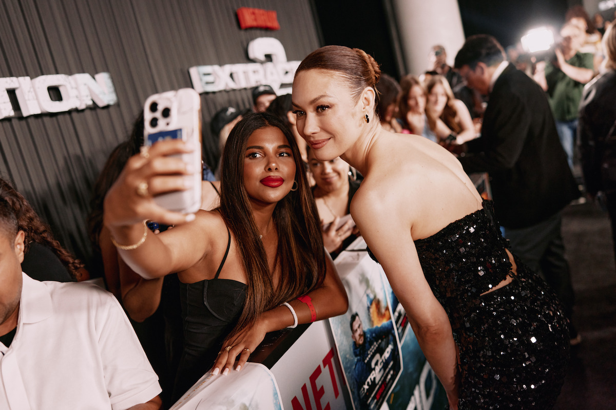 Orga Kurylenko takes a selfie with a fan at the Extraction 2 New York premiere.