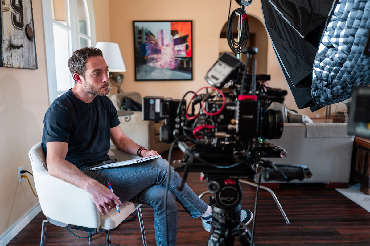 ‘Court of Gold’ director Jake Rogal sits behind a camera.