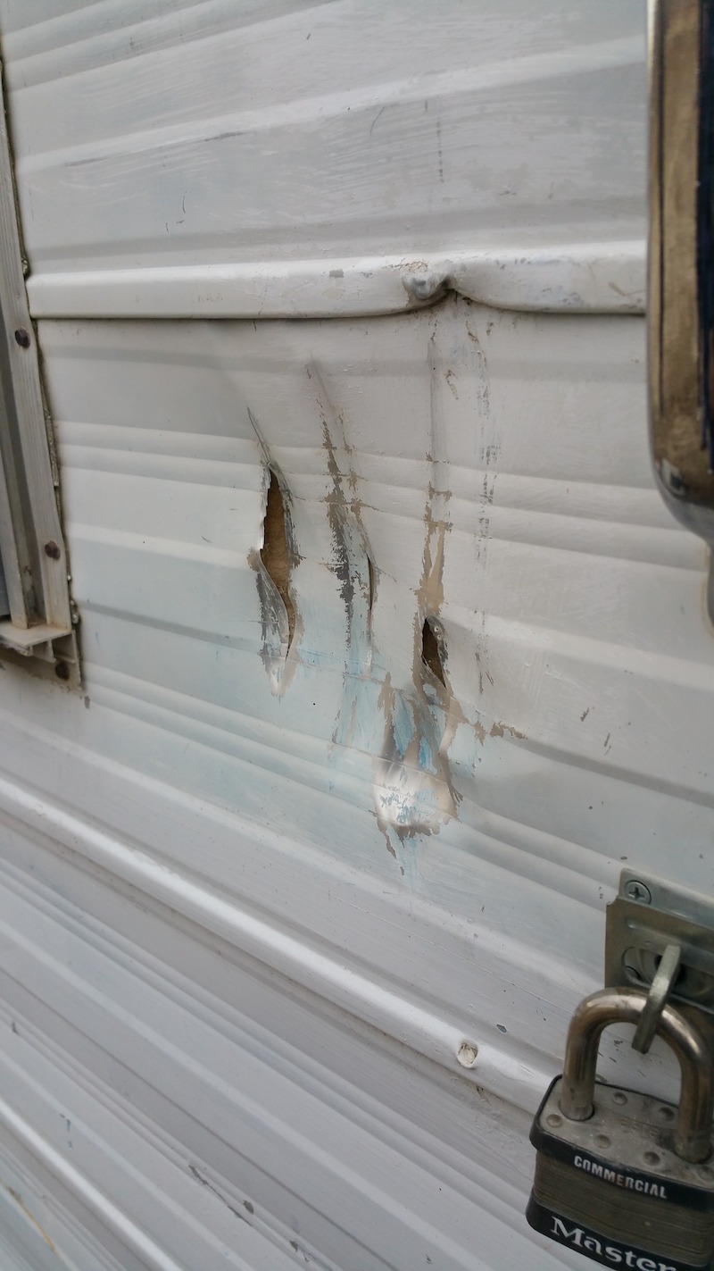 Photo of damage done to the side of a trailer in Upper Fruitland, NM, provided by Brenda Harris. - ‘Unsolved Mysteries’ Volume 3: ‘Paranormal Rangers’ - Evidence of Bigfoot