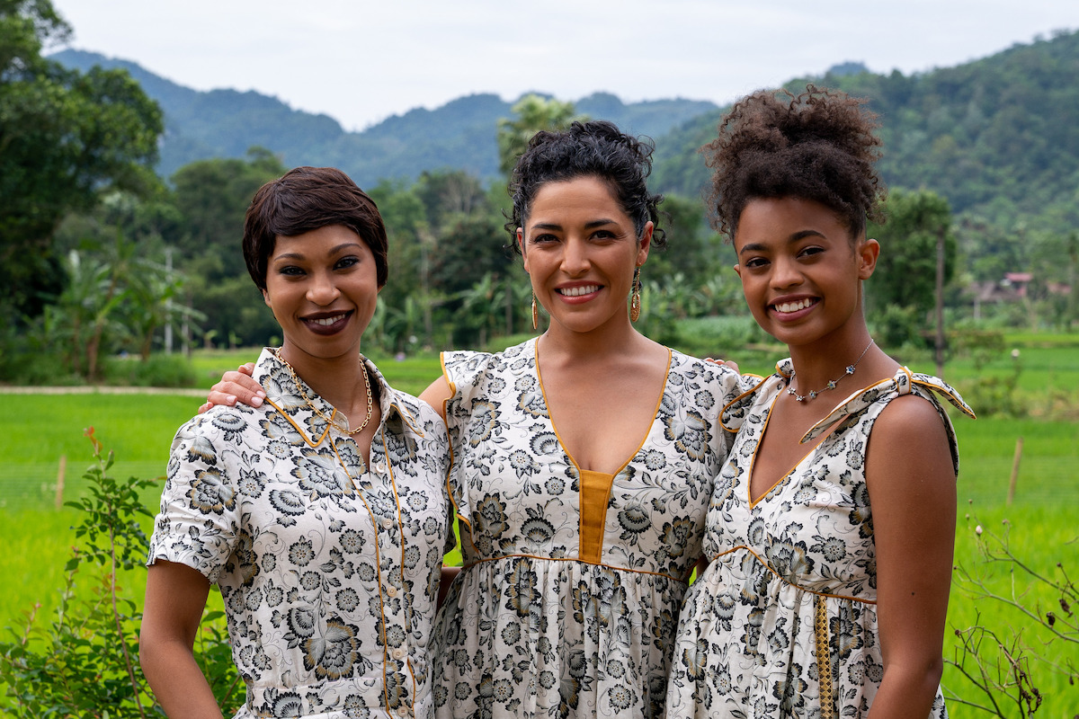 Three women stand in a green field in a still from ‘A Tourist’s Guide to Love.'