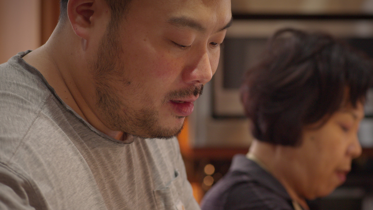 David chang and his mother prepare a meal together. 