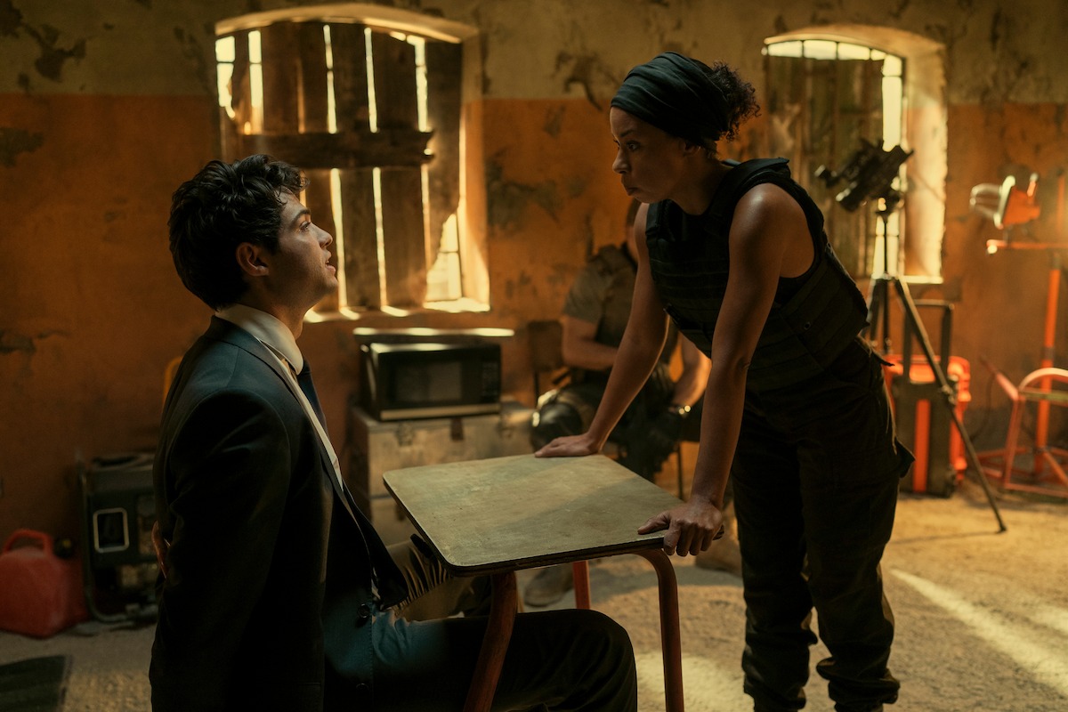 Noah Centineo sitting handcuffed.