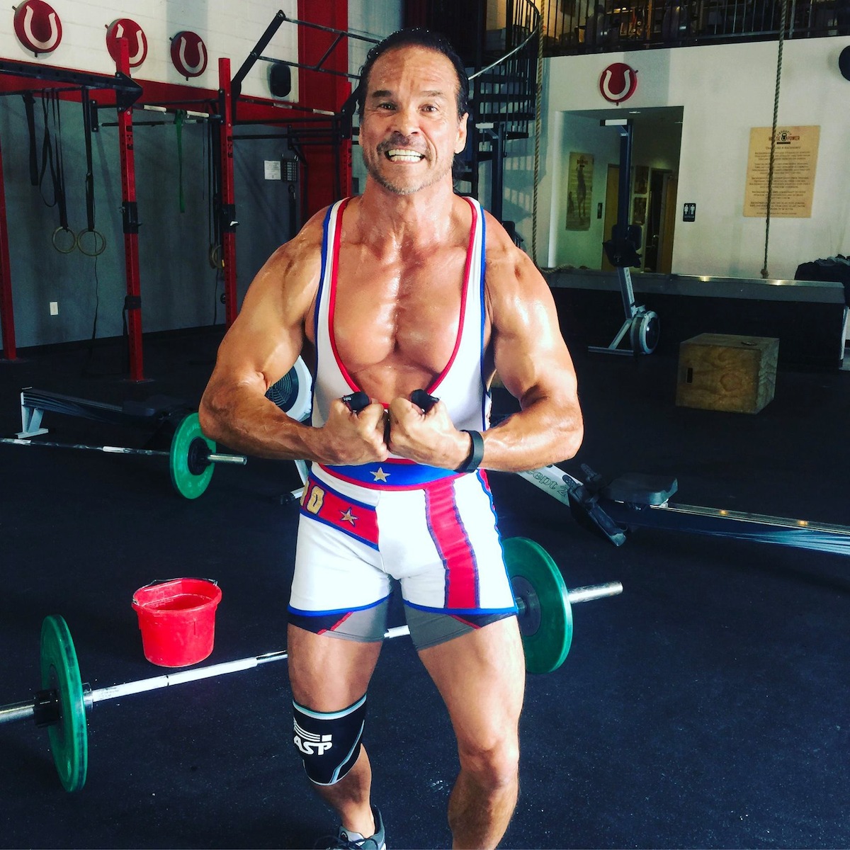 Dan Clark, who played Nitro in American Gladiators, flexing in his old spandex uniform.