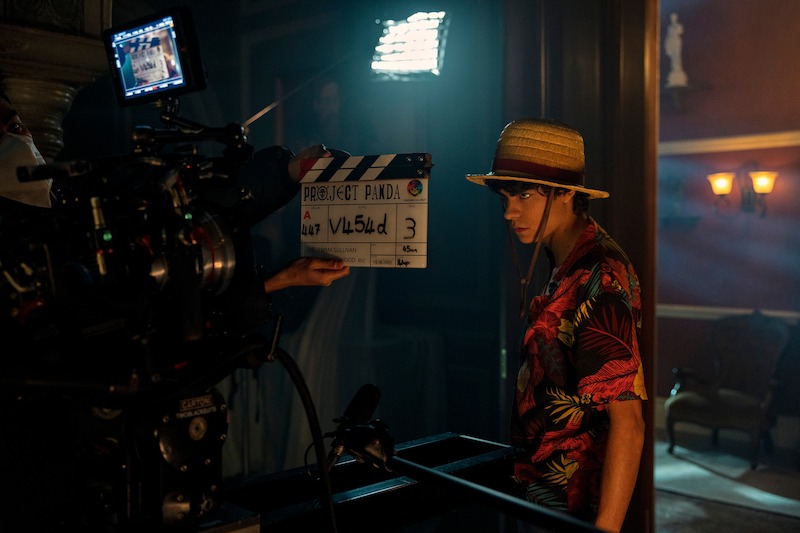 Iñaki Godoy as Monkey D. Luffy with a clapboard held in front of him in season 1 of 'One Piece.' 