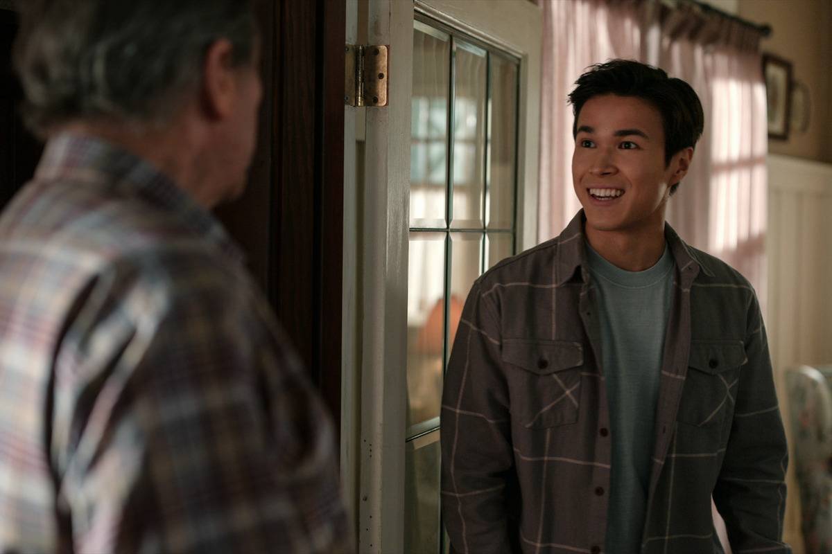 Kai Bradbury as Denny smiles wearing a gray flannel shirt in Season 4 of ‘Virgin River.’