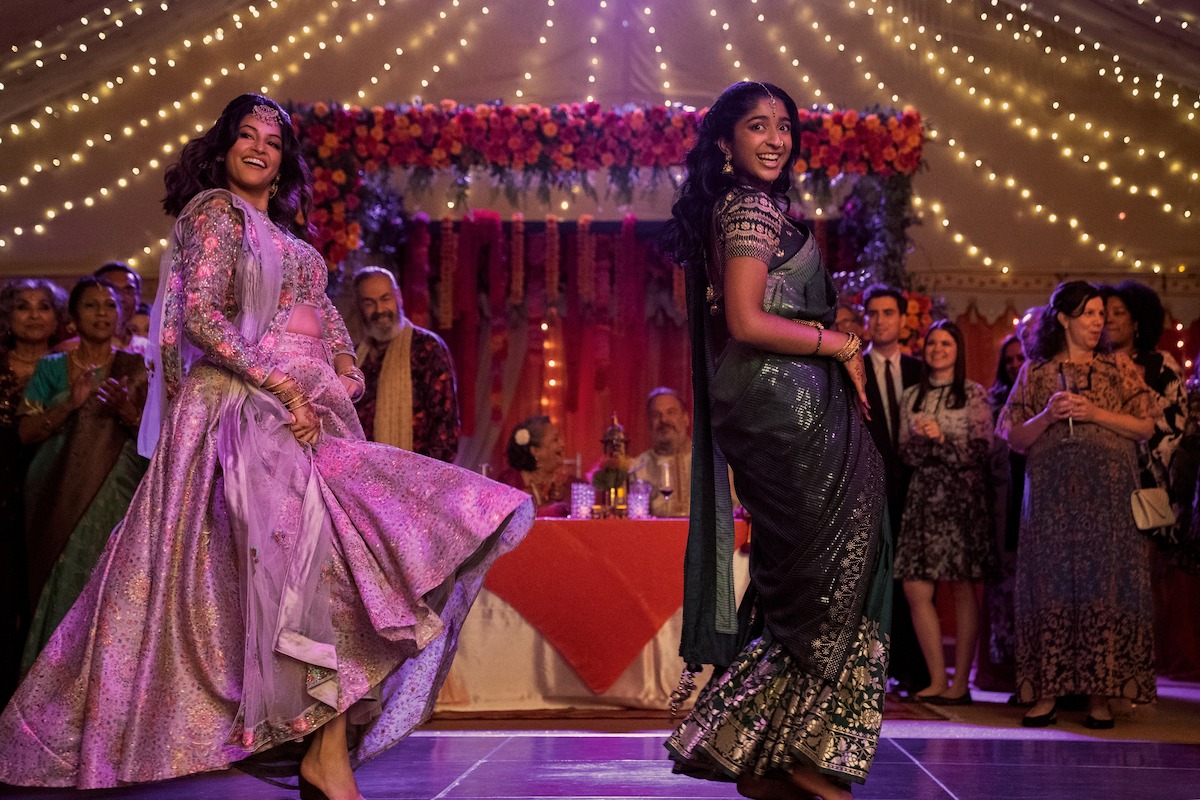Richa Moorjani as Kamala and Maitreyi Ramakrishnan as Devi dance on stage together in Season 4 of ‘Never Have I Ever.’ 