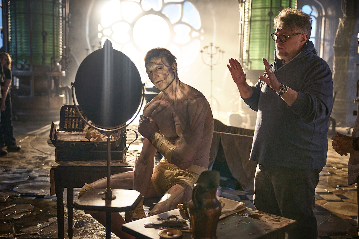 Jacob Elordi in character as the Creature being directed by Guillermo del Toro.