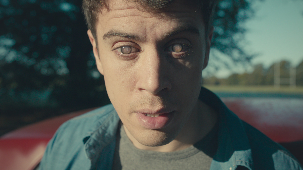 A man with milky eyes looks scared in 'Black Mirror'