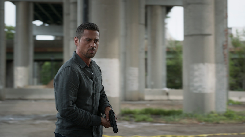 A man under a freeway overpass