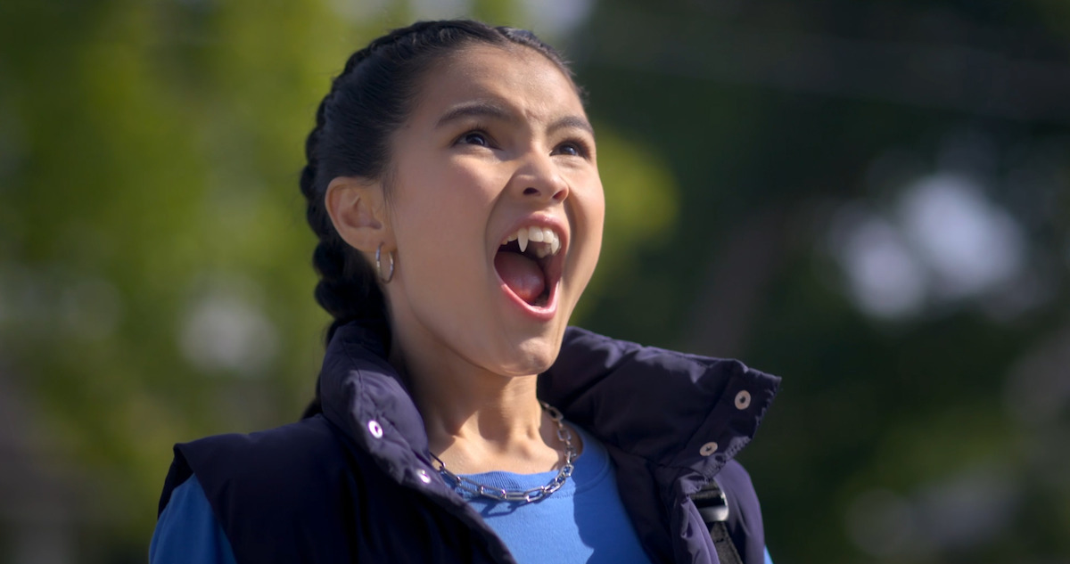 a vampire woman screaming and baring her fangs