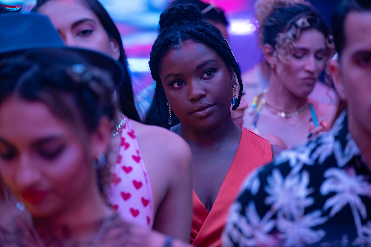 Courtney Taylor as Mia stands in a crowd at a party in Season 1 of ‘Neon.’