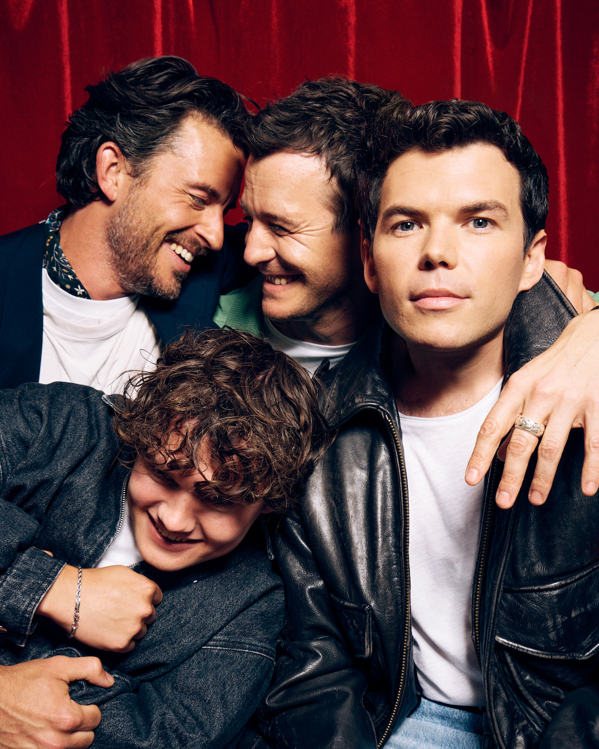 Jonathan Bailey, Luke Thompson, Luke Newton, and Will Tilston in a photo booth.