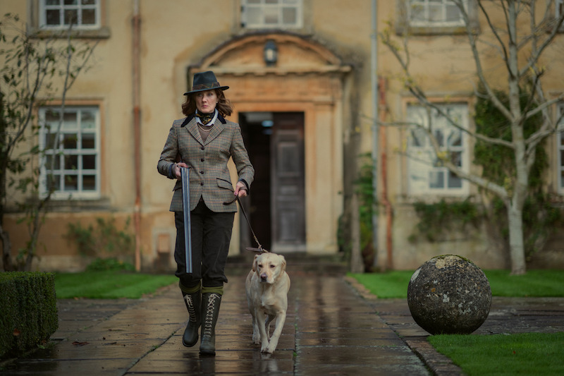 Richardson walks with a hunting dog and holds a shotgun in Season 1 of ‘The Gentlemen.’