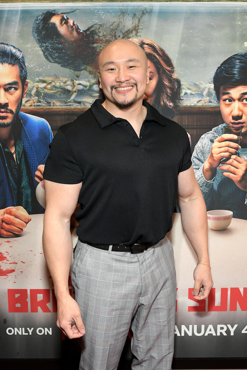 Jon Xue Zhang smiles brightly on the red carpet for Netflix's 'The Brothers Sun' Los Angeles Premiere at Netflix Tudum Theater 
