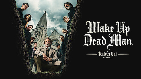 The Cast of Wake Up Dead Man looks into a grave