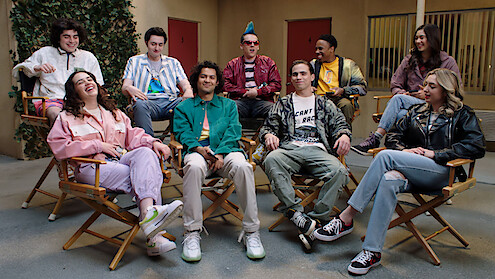 The cast of Season 6 of 'Cobra Kai' sits in chairs on set together