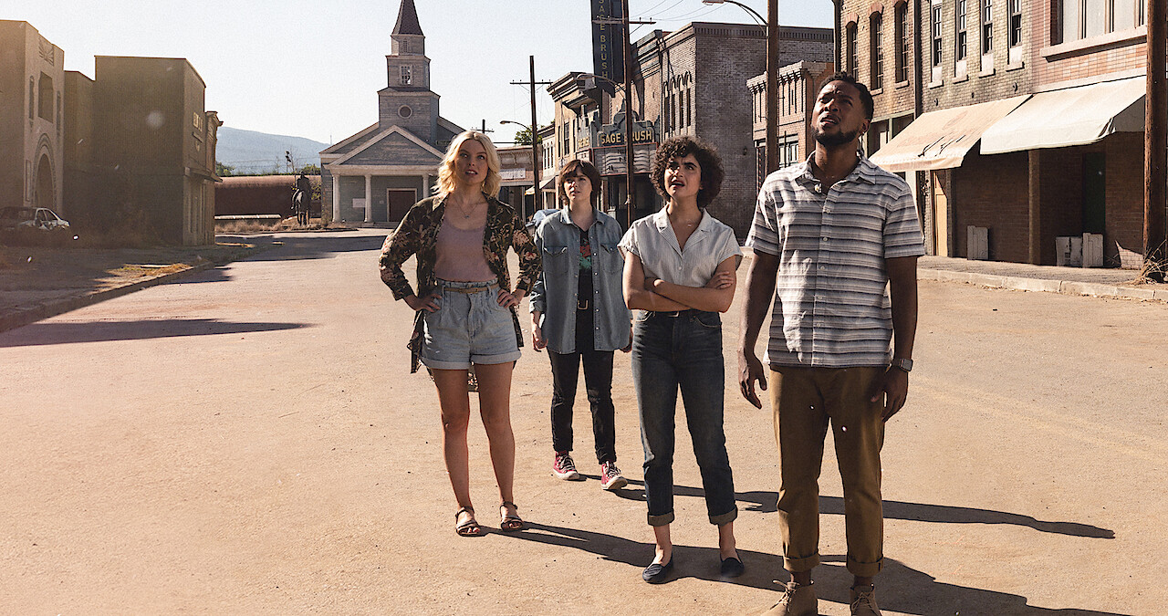 An image of the characters standing in the ghost town in Texas Chainsaw Massacre