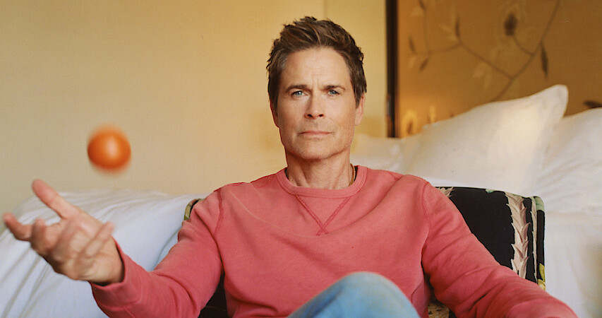 Actor Rob Lowe juggles an orange. 