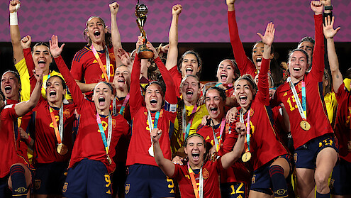 Spain teammates celebrate with the FIFA Women's World Cup Trophy