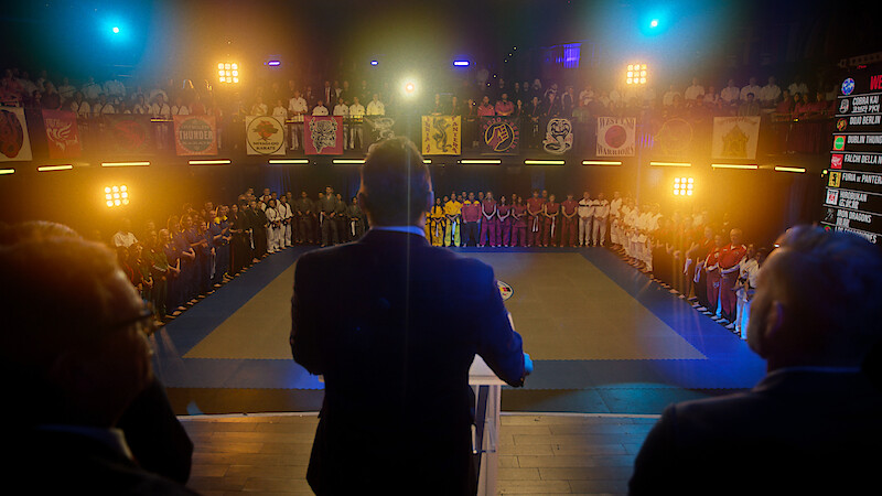 An announcer speaks at the Seikai Taikai in Season 6, Part 2 of 'Cobra Kai'