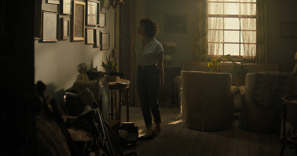 Melody is in the house looking at some pictures on the wall in the Texas Chainsaw Massacre
