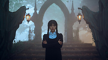 Jenna Ortega as Wednesday Addams stands in a graveyard in 'Wednesday'