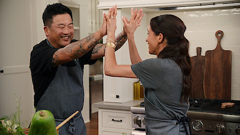 Roy Choi and Meghan high-fiving.