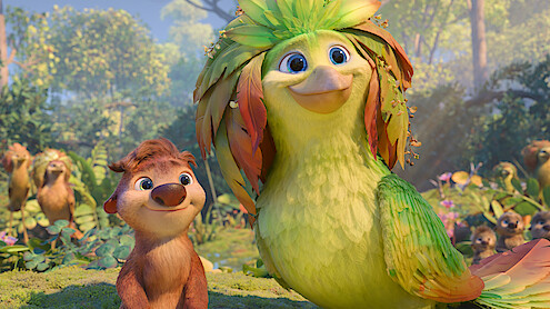 Animated forest scene with a smiling small brown furry creature and a large vibrant green bird with leafy feathers, surrounded by lush greenery, trees, and other animals in the background under daylight.