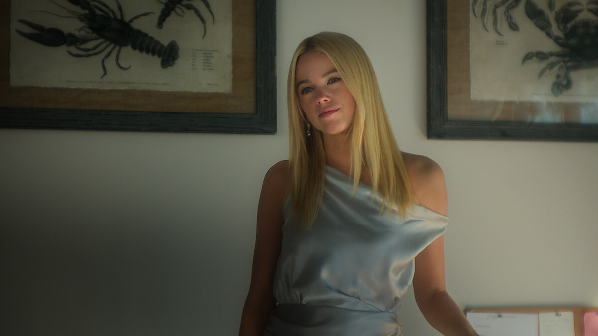 Still of Milly Alcock in a blue dress