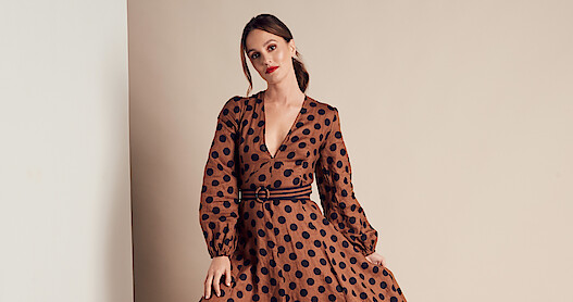 A glamor shot of Leighton Meester in a brown dress with black polkadots