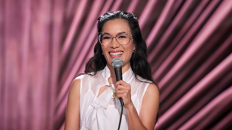 Comedian Ali Wong on stage with microphone in her hand during her stand-up special 'Single Lady'.