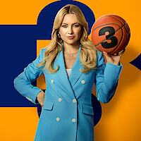 Woman in a blue blazer holds a basketball marked with the number 3, standing confidently in front of a yellow and navy blue graphic background.