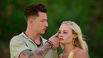Grant wipes a tear away from Ashley's face