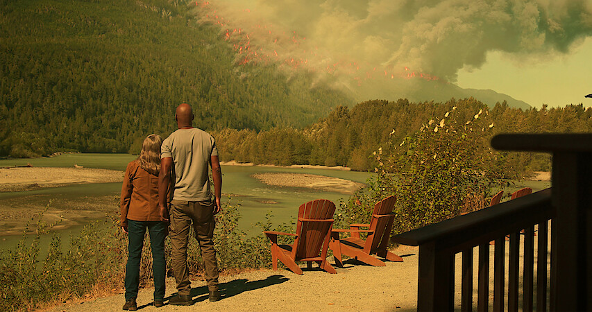Annette O’Toole as Hope and Colin Lawrence as Preacher watch a wildfire blazes through the mountainside in Season 5 of 'Virgin River.'
