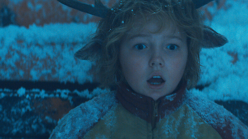 Christian Convery as Gus sits covered in snow with a surprised expression in season 3 of 'Sweet Tooth'