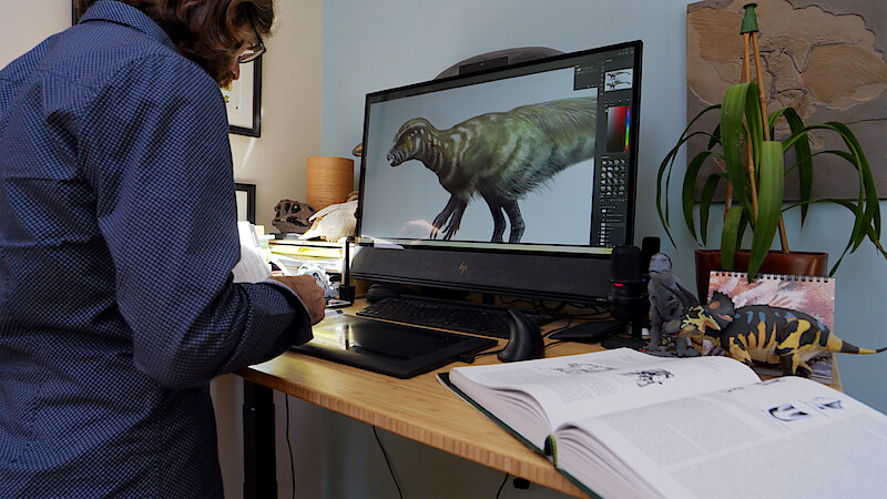 A person works at the computer on 'The Dinosaurs.'